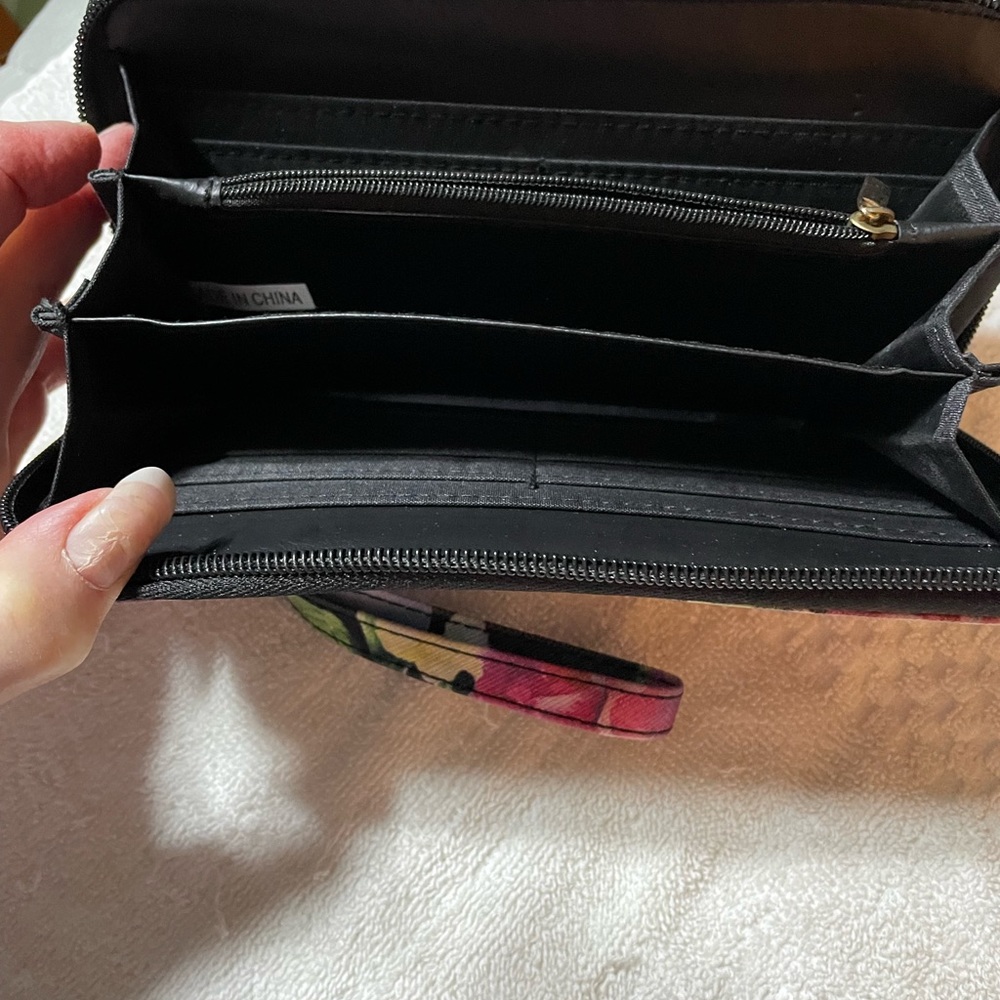 A floral vinyl wallet with 3 compartments and zippered change section